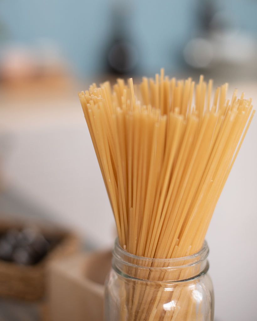 Pasta Category: Image is of dried spaghetti noodles standing in glass jar.
